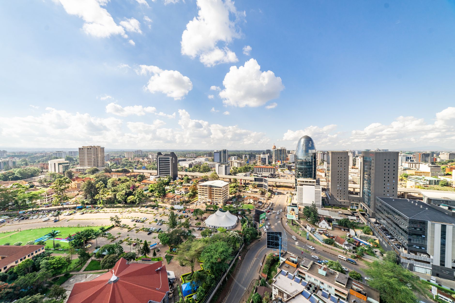 Modern Grade A office building in Nairobi with glass facade and city skyline backdrop.